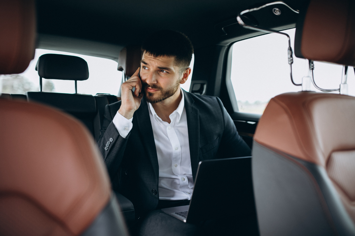 A professional chauffeur opening the car door for a passenger, showcasing luxury chauffeur service in Central London.